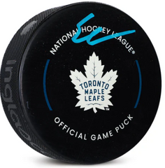 a hockey puck with the toronto maple leafs logo on it